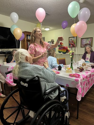 Residents celebrating with balloons in a common area