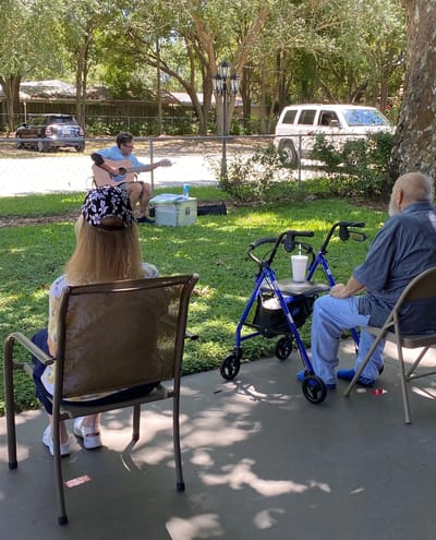 Residents enjoying a live music performance outside.