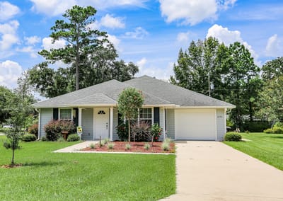 Exterior view of a residential building with well-maintained landscaping