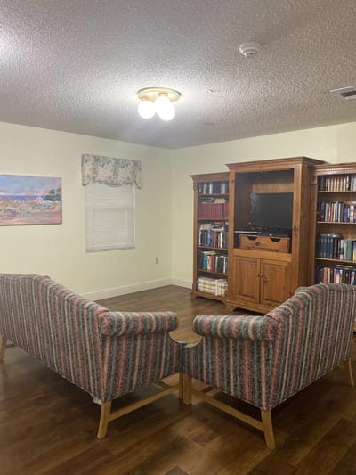 A cozy lounge area with bookshelves and seating