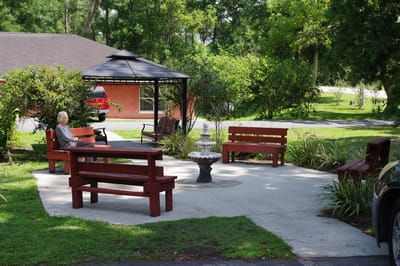 A resident enjoying a quiet outdoor seating area