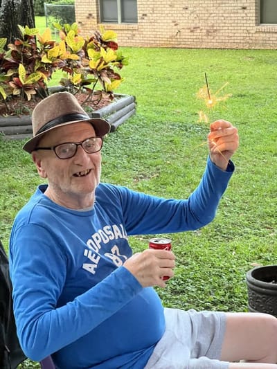 Resident celebrating outdoors with a sparkler