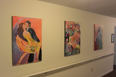 Art paintings displayed in a hallway