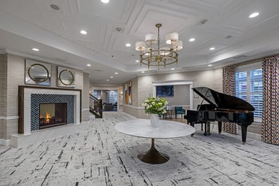 Bright common area with piano and fireplace