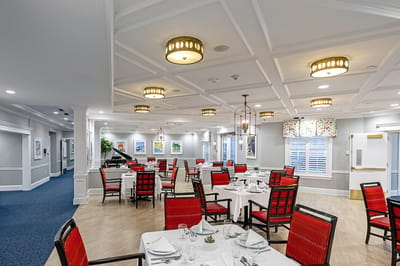 Dining area with red chairs and decorative lighting