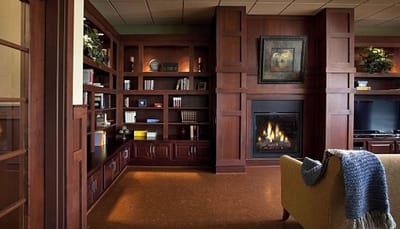 Cozy common area with bookshelf and fireplace