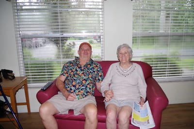 Two residents enjoying time together on a couch