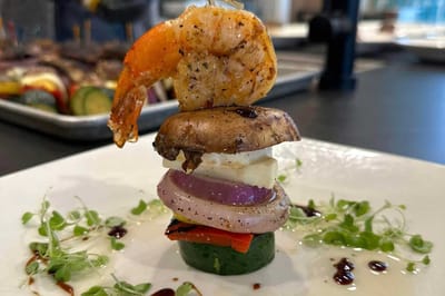 Gourmet meal plated with shrimp and vegetables