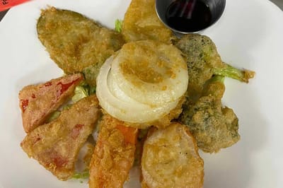 Plate of fried vegetables with dipping sauce
