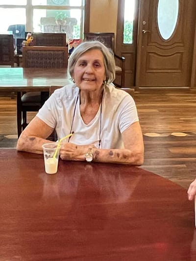 A resident enjoying a drink in a common area