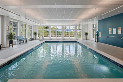 Indoor swimming pool area with large windows