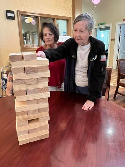 Residents playing Jenga in a common area