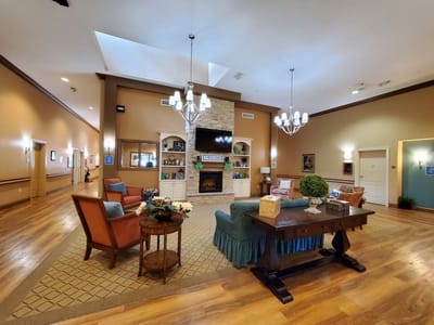 Bright common area with comfortable seating and a fireplace