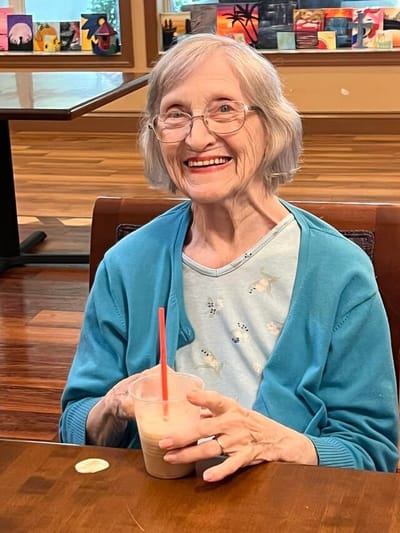 Resident enjoying a milkshake in a communal area
