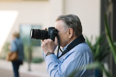 A resident photographing outdoors with a camera