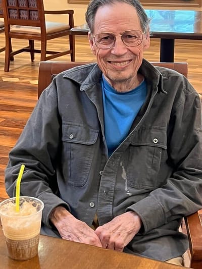 Resident enjoying a drink in a common area