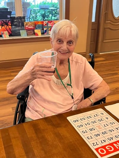 Resident enjoying bingo in a lively common area