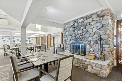 Interior dining area with stone fireplace and tables