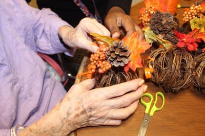 Residents engaging in a craft activity with decorations