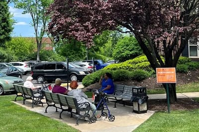 Residents enjoying time outdoors on benches