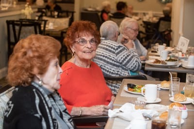 Residents enjoying a meal in the dining room