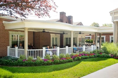 Residents enjoying the outdoor patio area with flowers
