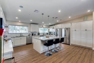 Modern kitchen interior with bar stools and appliances