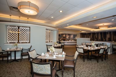 Dining room setup with tables and flowers