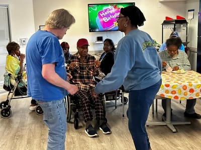 Residents celebrating a birthday in a common area