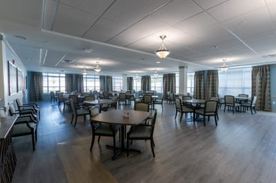 Bright dining room with tables and chairs arranged