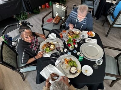 Residents enjoying a meal together in the dining room