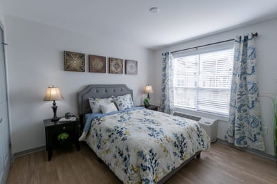 Cozy private room with a floral bedspread and decorations