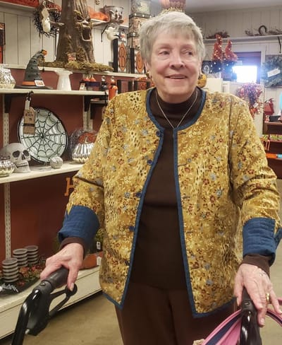 Resident smiling in a decorated common area