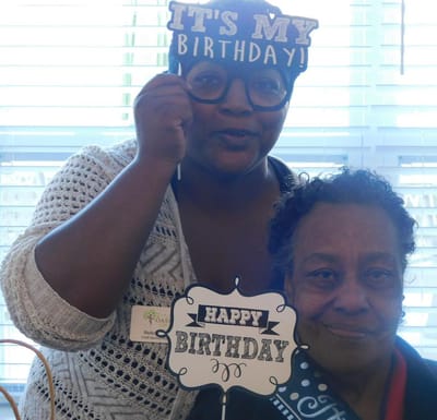Residents celebrating a birthday with props
