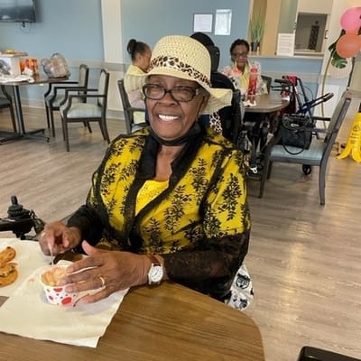 Resident enjoying a dessert in a social setting