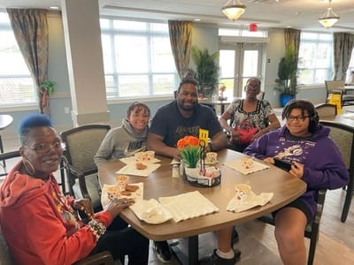 Residents enjoying snacks in a bright common area