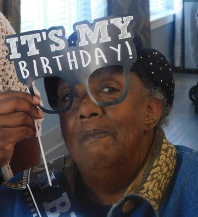 Resident celebrating birthday with props
