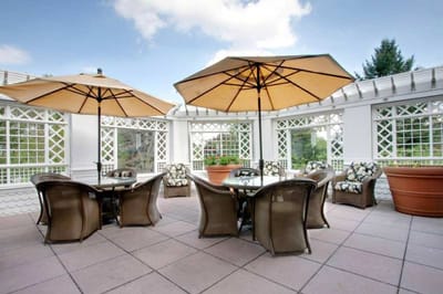 Outdoor patio area with umbrellas and seating