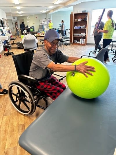 Resident engaging in activity with a fitness ball