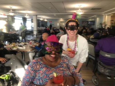 Residents and staff celebrating with drinks at a festive event