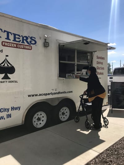 Resident using a walker at a food truck