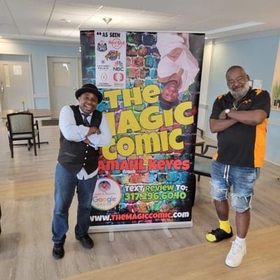Two men pose in a common area for an event