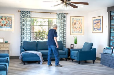 Common area with seating and a resident.