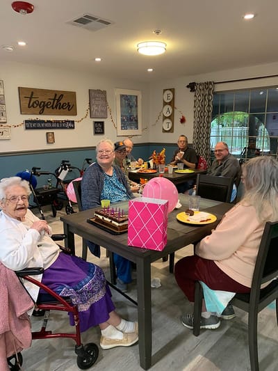 Seniors enjoying a meal together in a dining area.