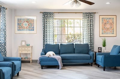Bright and inviting common area with blue furniture.