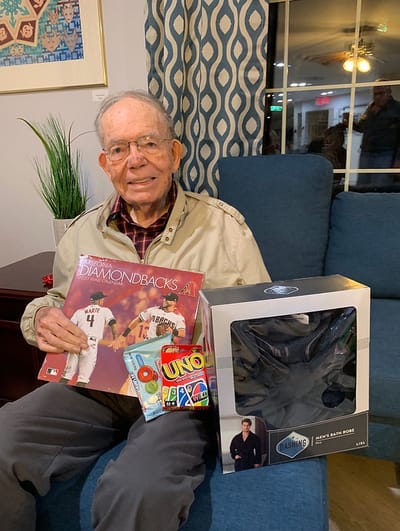 Elderly resident with games and a magazine