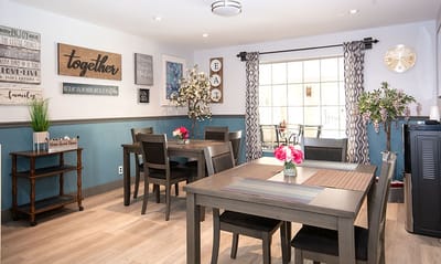 Bright common area with dining tables and decor.