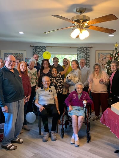 Residents and staff celebrating together with decorations.