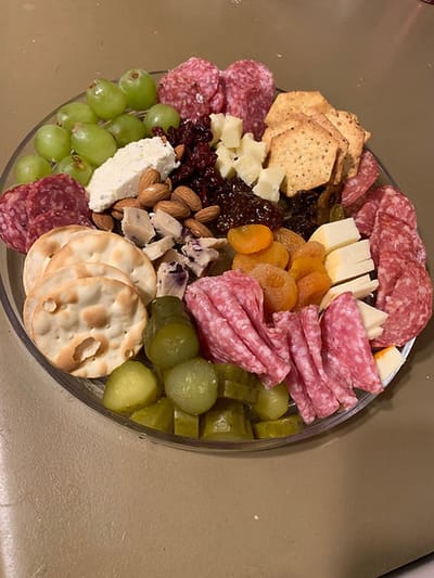 Platter of assorted cheeses, meats, and fruits