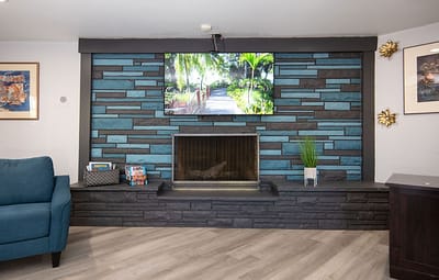 Cozy interior common area with a fireplace and TV